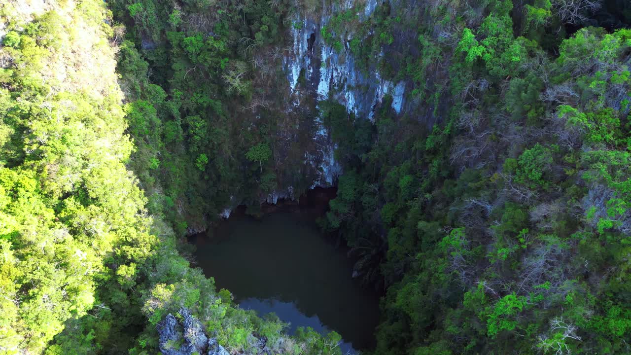 secret lagoon Railay Beach in Krabi, Thailand, featuring limestone cliffs and turquoise water. Perfect aerial view flight tilt up drone
