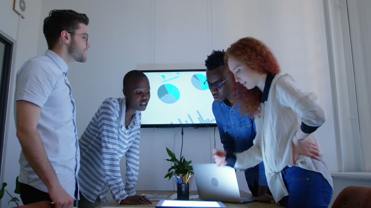 Side view of young mixed-race business team planning and standing in meeting room in office 4k