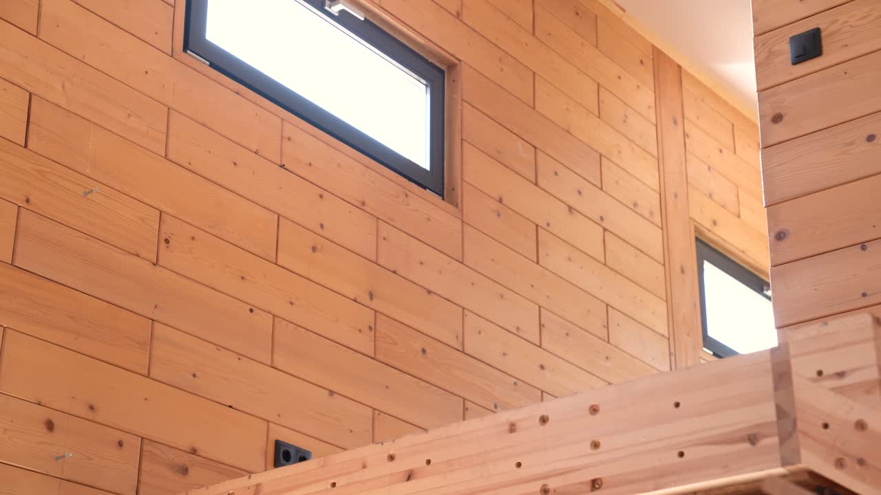 Wooden interior with vertical windows and natural light in prefabricated home