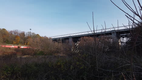 wide motion time lapse of traffic on toronto's danforth viaduct and don valley parkway, shot from below