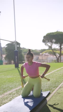 Woman exercising on a mat outdoors