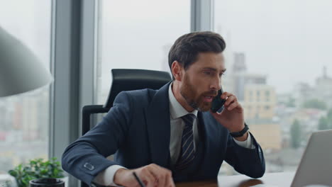 consultant working talking phone at office looking laptop screen close up.