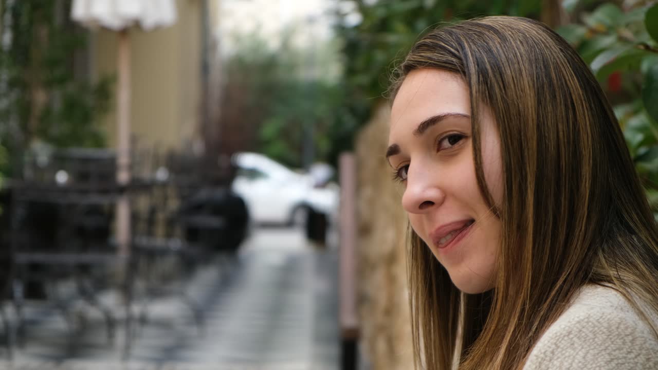 Beautiful girl posing to the camera and smiling