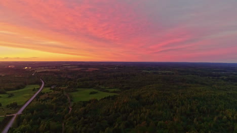 amazing twilight scene during sunset with forested countryside and country road