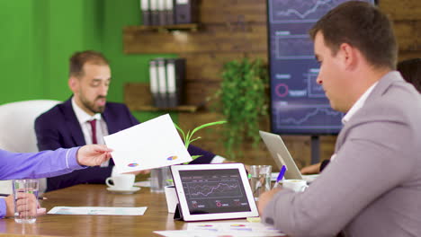 successful businessman reading charts on his tablet