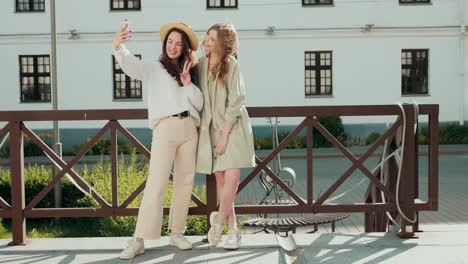 two young women taking a selfie outdoors