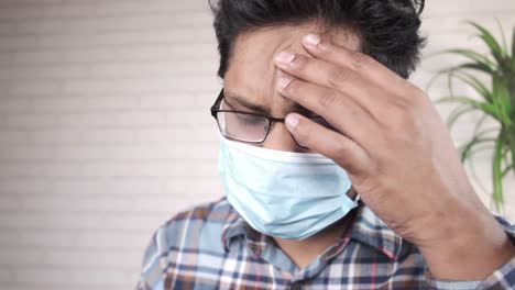 man wearing a face mask and glasses