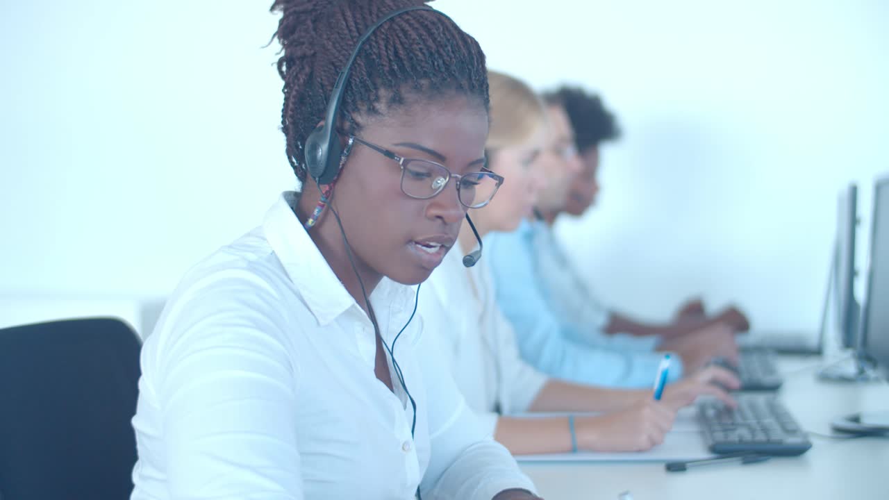 Serious contact center employee wearing headset