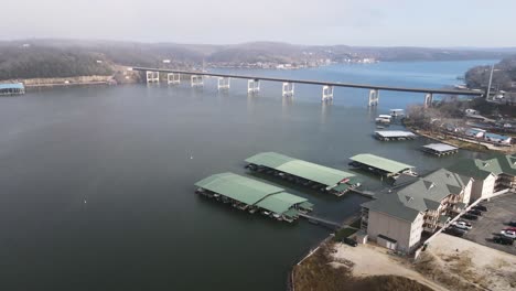 Boats-in-Harbor-by-Bridge-at-the-Lake-of-the-Ozarks,-Missouri---Aerial