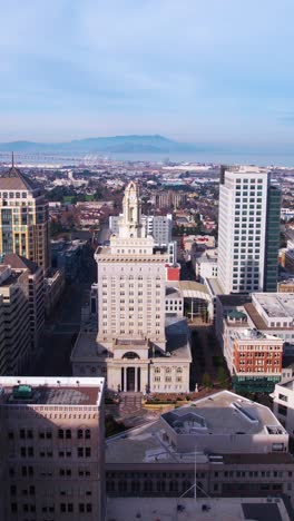 vertical aerial view, oakland city hall and downtown buildings, california usa, drone shot