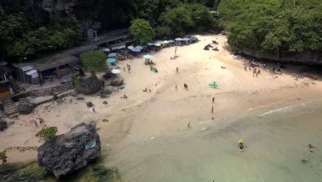 aerial dolly backward view of beach , padang padang beach on bali, indonesian, with surrounding trees