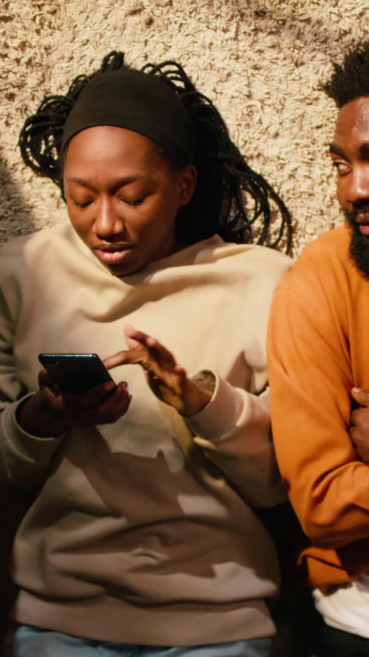 Vertical Video Distant man being rejected by offended displeased woman laying on the floor