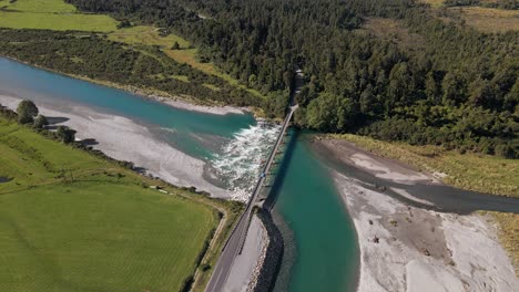 high angle view of bridge built over picturesque, turquoise river