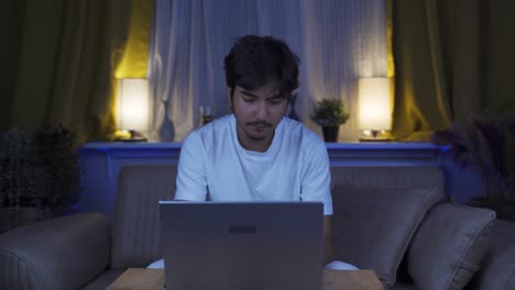 Man-looking-tired-and-exhausted-at-laptop-at-night.