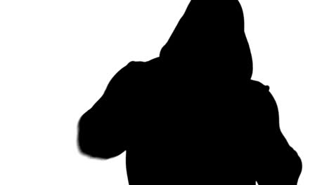 muscular silhouette of man wearing hood boxing