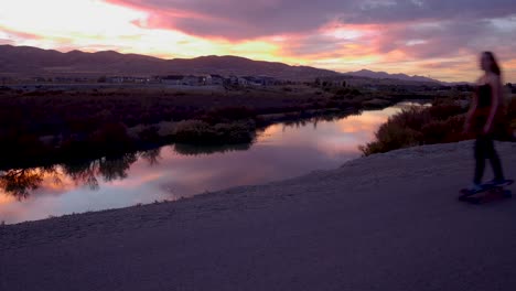 Skateboarders-glide-through-a-static-scene-with-an-amazing-sunset-in-the-background