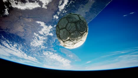 old soccer ball in space on earth orbit