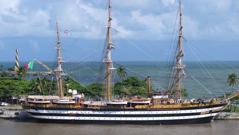 Aerial-orbiting-shot-of-Italian-training-ship-Amerigo-Vespucci-at-port-of-Santo-Domingo-during-world-tour,-Dominican-Republic