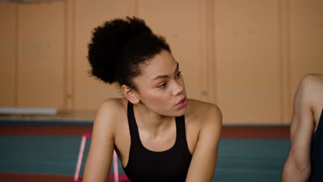 serious athlete with afro hair talking