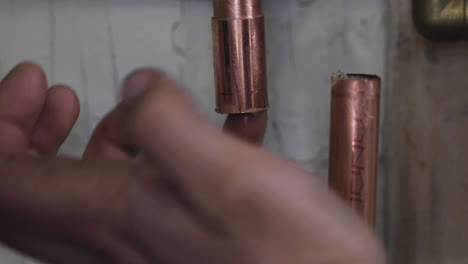 flux being applied to a copper coupler before a pipe is soldered during a burst pipe repair