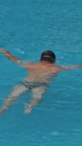 man swim in the pool at the hotel