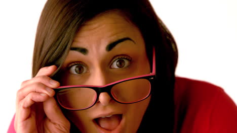 shocked brunette tilting down her glasses