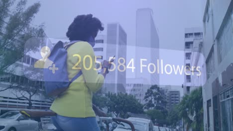 animation of social media notification over african american woman in mask using phone in street