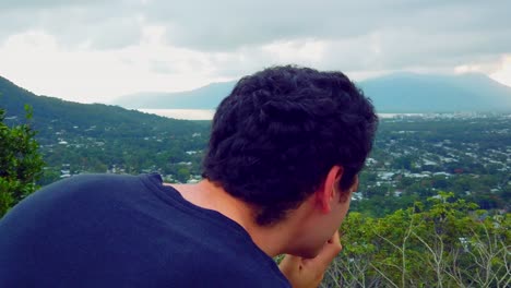 photographer taking photos of cairns early in the morning when clouds are still over the mountians, slow motion