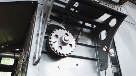 Close-up of a rusty gear and chain mechanism on an industrial machine