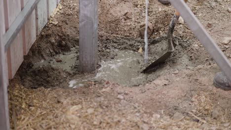 watering the soil on the support poles to make it solid when installing paving blocks