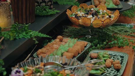 fresh salad with nuts herbs and edible flowers served in decorative glass bowl