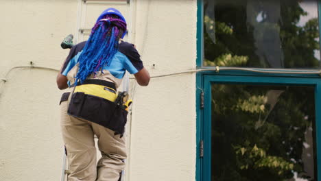 hvac repairman climbs down on ladder