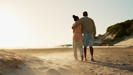 couple walking on the beach at sunset