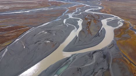 many river streams confluence with grey slit and mud in brown plains