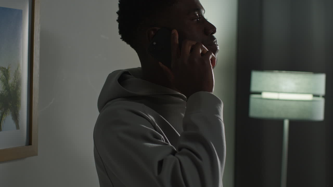 Young Man At Home Talking On Mobile Phone Reacting And Looking Upset After Getting Bad News 4