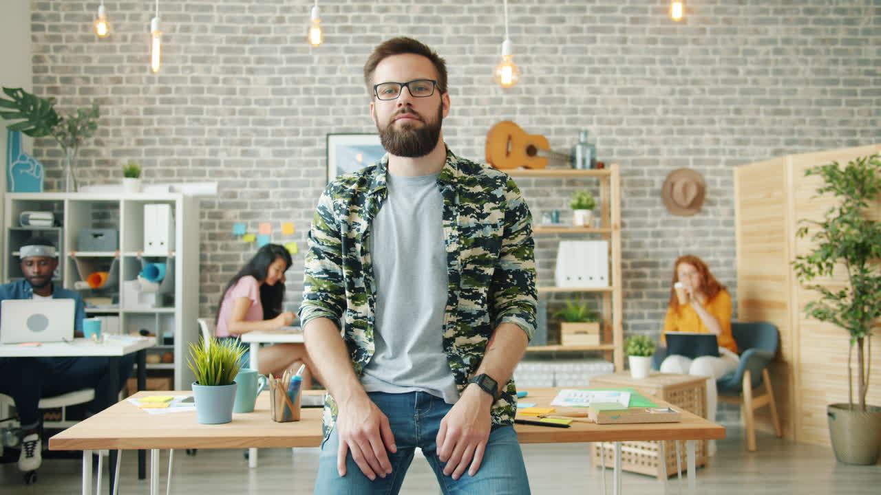 Man standing in front of a busy office
