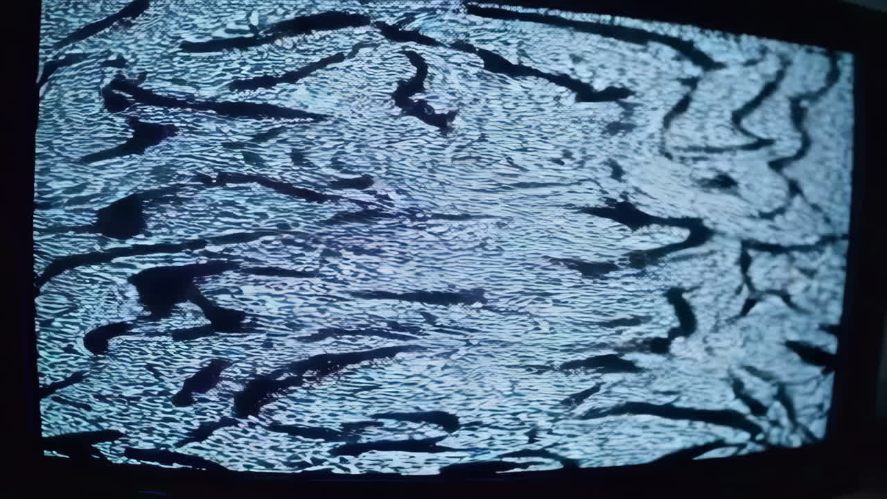 Person sitting in a dark room in front of a computer monitor