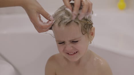 Attractive-three-years-old-girl-takes-a-bath.-Cute-blonde-child