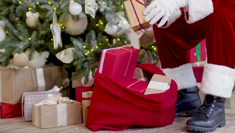 Static-shot-of-the-Santa-Claus-keeping-gifts-near-the-Christmas-trees