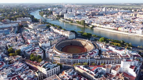 seville bullring, maestranza theater, and torre del oro by the guadalquivir river in seville, spain