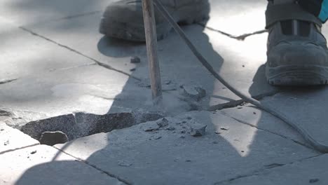 jackhammer breaking paving stones