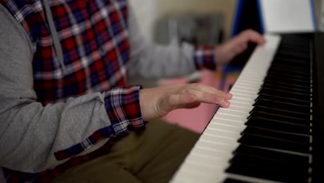 hands of men play on the electronic synthesizer