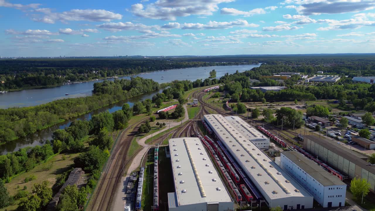 Hennigsdorf railway factory train depot overlooking the river in Brandenburg, Germany. Fantastic aerial view flight ascending drone