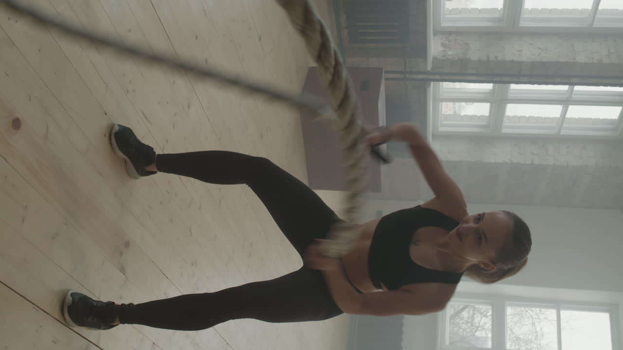 Sportswoman Doing Battle Rope Exercise
