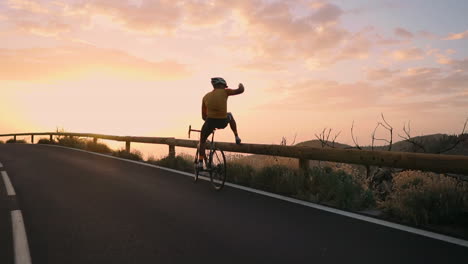 in slow motion, a professional cyclist in helmet and sports gear stands at the mountain's edge, capturing a stunning view with a mobile phone