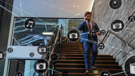 Network-of-digital-icons-against-caucasian-businessman-climbing-down-the-stairs-at-office