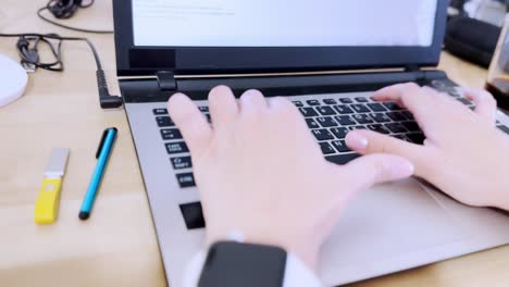 side view highlighting female hand position and ergonomics while typing on a laptop