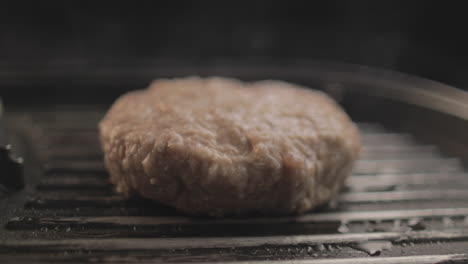 Beef-or-Chicken-Burger-on-grill-being-prepared-for-a-delicious-Hamburger-sandiwich-,-with-a-black-background-and-simple-light-set-up-shot-on-RAW-4K