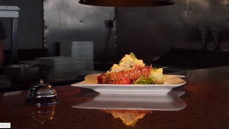 lobster meal set out on the restaurant counter in a plate at a outdoor beach side dining place