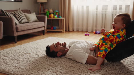 joyful father and baby playtime at home